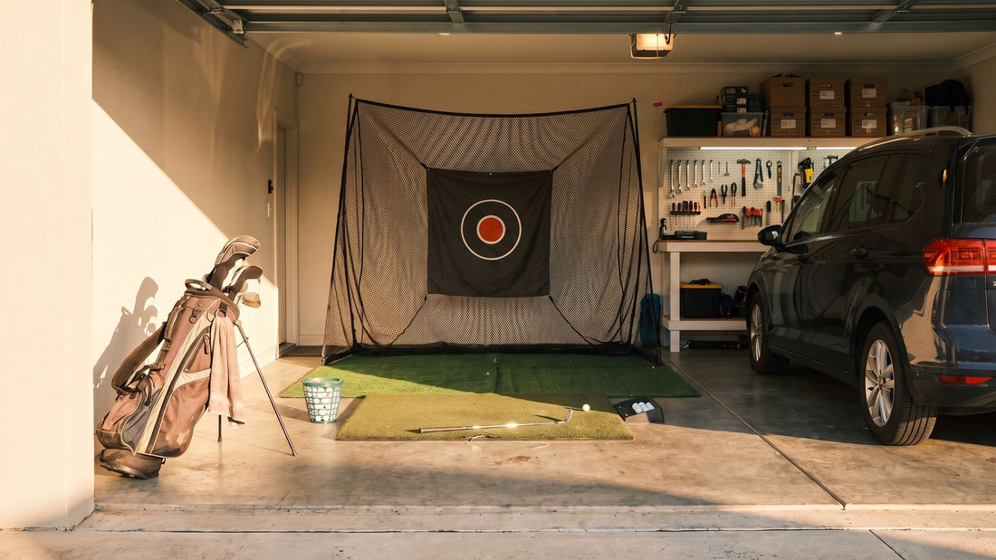 A double garage practice bay with a net, hitting mat and golf bag, and the car parked alongside